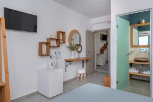 a room with a kitchen with a sink and a mirror at Gizis Cliffside Suites in Imerovigli +127 photos