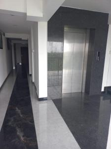 an empty hallway of a building with white and black walls at Serene Enclave in Nedumbassery