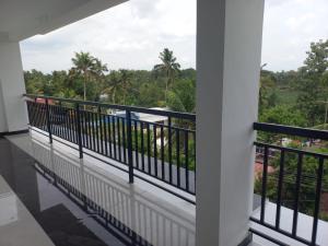 a balcony with a view of the jungle at Serene Enclave in Nedumbassery