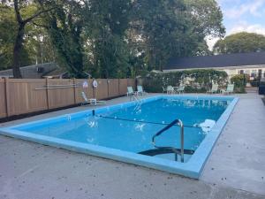 a large swimming pool in a yard at Cape Cod Motor Inn in South Yarmouth