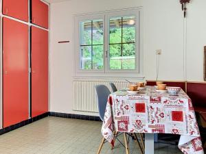 a dining room with a table and chairs and a window at Apartment Chalet Clairval by Interhome in Charmey