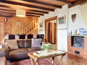 a living room with a couch and a fireplace at Apartment Chalet Clairval by Interhome in Charmey +28 photos