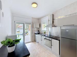 a kitchen with a sink and a stove at Holiday Home Requesens by Interhome in Empuriabrava