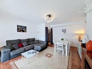 a living room with a couch and a table at Holiday Home Requesens by Interhome in Empuriabrava