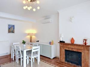 a dining room with a table and chairs and a fireplace at Holiday Home Requesens by Interhome in Empuriabrava +29 photos