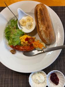 a plate of food with a egg and a sandwich at 西古見の宿だるま in Setouchi