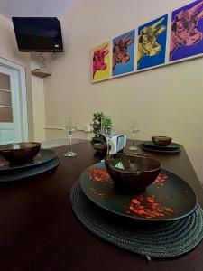 a dining room table with bowls and plates on it at Family Boutique in Veliko Tŭrnovo