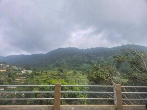 a view of a mountain with a fence at The Green County Homestay in Panglipurgalin