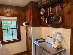 a kitchen with a counter with a blender and a window at Cape Cod Motor Inn in South Yarmouth