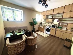 a kitchen with a table and chairs in a room at Family Boutique in Veliko Tŭrnovo