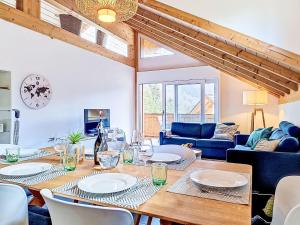 a living room with a wooden table and chairs at Apartment Momento by Interhome in Kandersteg +24 photos