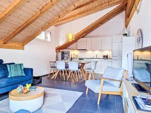 a living room with a blue couch and a table at Apartment Momento by Interhome in Kandersteg