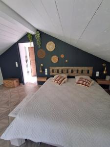a bedroom with a large bed with two pillows at Domaine Plan Bois in Ballaison