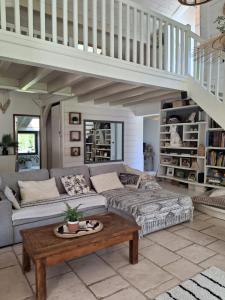 a living room with a couch and a table at Domaine Plan Bois in Ballaison