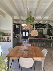 a kitchen and dining room with a wooden table and chairs at Domaine Plan Bois in Ballaison