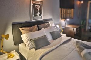 a bedroom with a large bed with pillows on it at Loft Industrial in Santo André
