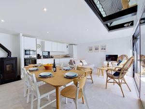 a dining room and living room with a table and chairs at Holiday Home Ker Bernic by Interhome in Piriac-sur-Mer