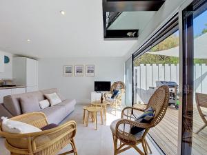 a living room with a couch and chairs at Holiday Home Ker Bernic by Interhome in Piriac-sur-Mer +29 photos