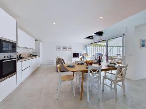 a kitchen and dining room with a table and chairs at Holiday Home Ker Bernic by Interhome in Piriac-sur-Mer