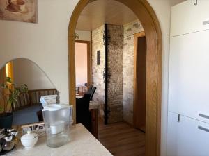 a kitchen with a table with a vase on a counter at Ferienwohnung Patrycja in Weissenbach am Lech +34 photos