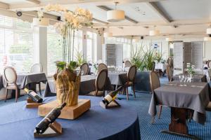 a dining room with tables and chairs and a room with tables andweapons at Beach Hut Suites in Bognor Regis