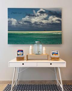 a white desk with a picture of the ocean at Hotel Rosanna 3 Stelle Superior in Lido di Jesolo