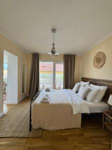 a bedroom with a large bed and a window at Villa Schober Baška in Baška