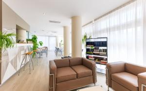 a living room with two chairs and a couch and a table at Hotel Rosanna 3 Stelle Superior in Lido di Jesolo +45 photos