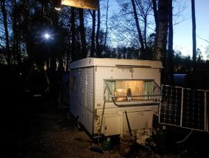 an rv parked in the woods at night at Yupfssi camp in Riga +5 photos
