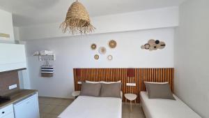 a living room with a couch and a table at Edelweiss Rent Rooms-Rent a Car in Tsoutsouros