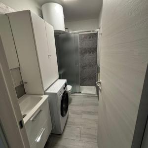 a bathroom with a washing machine and a shower at Nido di Pace in Giardini Naxos