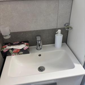 a white sink in a bathroom with a mirror at Nido di Pace in Giardini Naxos