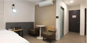a hotel room with a bed and a table and chairs at Hound Hotel Incheon Seogu in Incheon +107 photos