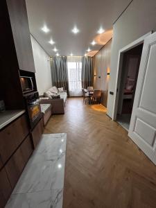 a living room with a couch and a table at River city-Сайран in Almaty