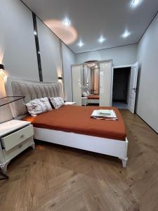 a bedroom with a large bed in a room at River city-Сайран in Almaty