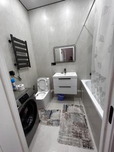 a bathroom with a washing machine and a washer at River city-Сайран in Almaty