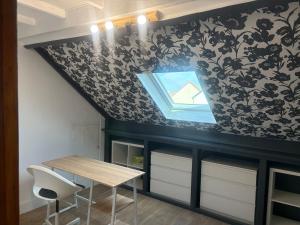 a dining room with a table and a window at Cozy apartment in Germainville +2 photos