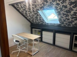 a table and a chair in a room at Cozy apartment in Germainville