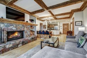 a living room with a stone fireplace at Arrowhead Village, A Vail Resorts Property in Edwards