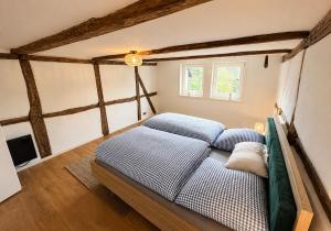 a bedroom with a bed in a room with beams at Anis Obsthof in Bad Arolsen