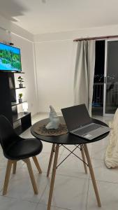 a laptop sitting on a table in a living room at Norte Urban Suites in Resistencia