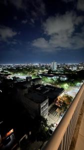 a view of a city at night from a balcony at Norte Urban Suites in Resistencia