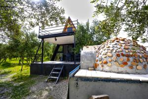 a building with a ladder next to a pile of food at Villa Olivia in Elbasan +93 photos