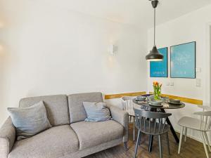 a living room with a couch and a table at Apartment Seewind by Interhome in Lembruch