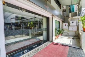 a glass door of a building with a red carpet at FabHotel Backstreet, Bhopal Railway Station in Bhopal