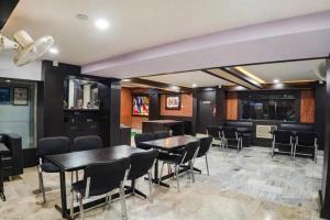 a dining room with a table and chairs at FabHotel Backstreet, Bhopal Railway Station in Bhopal