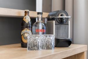 a bottle of wine and glasses on a table at NEU - Sona Design Rooms - CITY CENTER - in Bamberg +51 photos