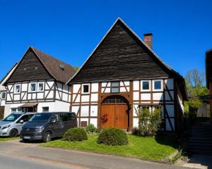 a house with a van parked in front of it at Anis Obsthof in Bad Arolsen