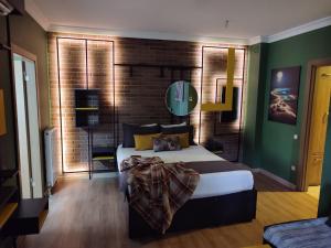 a bedroom with a bed and a brick wall at BUTİK 24 SUİTES in Ankara