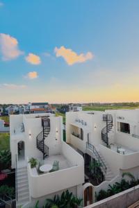 arial view of a white apartment building with stairs at Enso Villa and Hotel in Munggu
